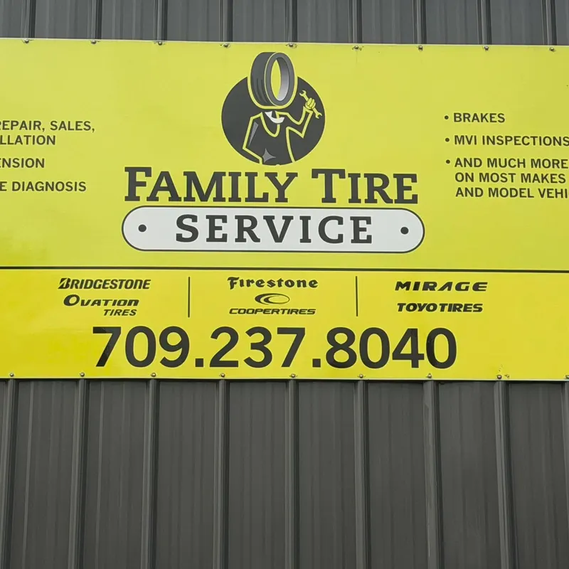 Yellow Family Tire Service sign on the shop wall listing tire repair, sales and installation, brakes, MVI inspections and the phone number 709.237.8040, with Bridgestone, Firestone, Ovation, Cooper, Mirage and Toyo tires
